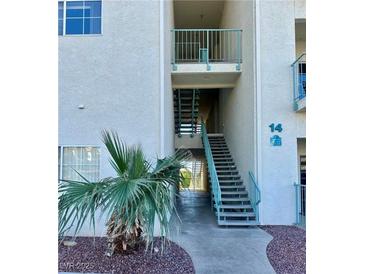 Exterior view of unit 14 featuring stairwell and desert landscaping at 3550 Bay Sands Dr # 2097, Laughlin, NV 89029