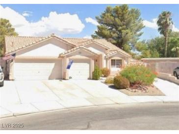 Charming single-story home with a tile roof, two-car garage, and well-maintained front yard landscaping at 4600 Windy Hollow St, Las Vegas, NV 89130
