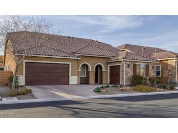 Charming single-story home featuring a tile roof, two-car garage, and tasteful desert landscaping at 6021 Vista Clara St, Las Vegas, NV 89148