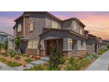 Charming multi-story home with well-manicured front yard and welcoming entrance at 6208 Rathbone St, Las Vegas, NV 89166