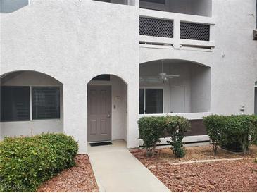 Inviting condo exterior with landscaped garden and private entrance and covered balcony with ceiling fan at 700 Carnegie St # 2013, Henderson, NV 89052