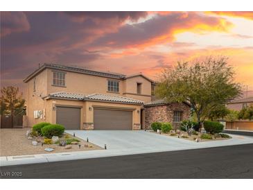 Two-story home with a three-car garage, desert landscaping and dramatic clouds behind the house at 8115 Cowboy Springs St, North Las Vegas, NV 89085