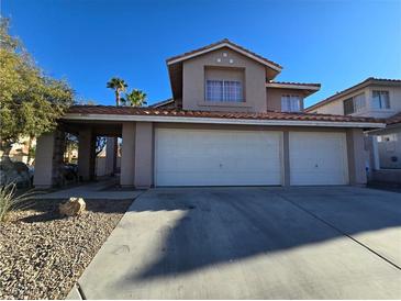 Charming two-story home featuring a three-car garage, desert landscaping, and a well-maintained front yard at 8401 Luna Bay Ln, Las Vegas, NV 89128