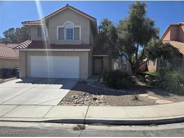 Charming two-story home features a two-car garage and well-maintained landscaping at 8771 Martinique Bay Ln, Las Vegas, NV 89147