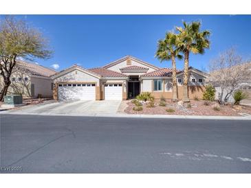 Charming single-story home featuring a three-car garage, desert landscaping, and tile roof at 8894 Don Horton Ave, Las Vegas, NV 89178