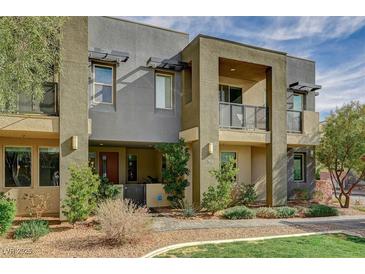 Beautiful three-story townhouse featuring modern architectural design and desert landscaping at 1541 Unison Way # 102, Las Vegas, NV 89135