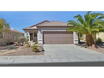 Charming single-story home with a landscaped front yard and two-car garage at 3036 Monroe Park Rd, Henderson, NV 89052