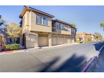 Attractive condo building with multiple garages and manicured landscaping at 3915 Palm Beach St # 201, Las Vegas, NV 89129
