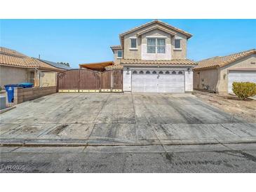 Inviting two-story home showcasing a wide driveway and a secure, decorative gate for added privacy at 5364 Awbury Ave, Las Vegas, NV 89110