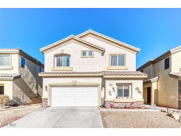 Two-story home featuring a two-car garage and low maintenance front yard landscaping at 9692 Waukegan Ave, Las Vegas, NV 89148