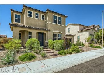 Inviting two-story home with well-maintained landscaping and a charming entryway at 10271 Bark Pine Ct, Las Vegas, NV 89166