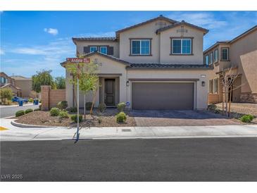 Two-story home featuring a neutral color scheme, a two-car garage, and low maintenance landscaping at 10367 Andele Ave, Las Vegas, NV 89166