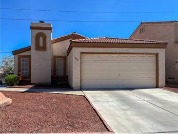 Charming single-story home featuring a two-car garage, desert landscaping, and a tiled roof at 1636 Royal Palm Dr, Las Vegas, NV 89128