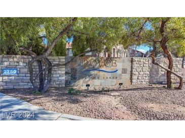 Stone sign reading 'Dolce At The Lakes' surrounded by trees and landscaping at 2750 S Durango Dr # 2027, Las Vegas, NV 89117