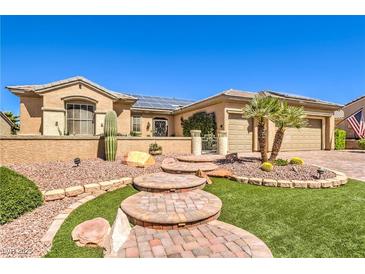 Charming single-story home boasting lush desert landscaping, walkway and attached two-car garage at 2776 White Sage Dr, Henderson, NV 89052