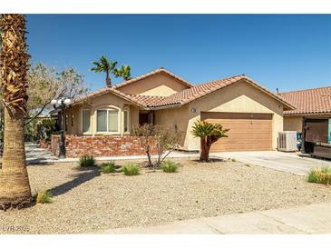 Charming single-story home featuring desert landscaping, a two-car garage, and a tile roof at 388 Coronado Dr, Henderson, NV 89015