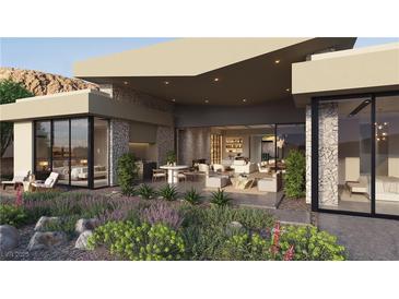 This home features a beautiful backyard with a stone facade, an outdoor kitchen, and bedrooms with exterior access at 6 Kaya Canyon Way # 14, Henderson, NV 89012