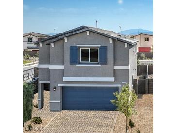 Charming two-story home with blue garage door, shutters, and brick driveway at 7449 Bosco Dr # Lot 106, North Las Vegas, NV 89084