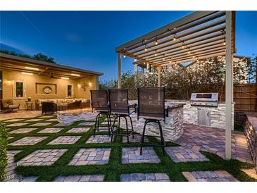 This outdoor kitchen has a built in grill and is perfect for outdoor entertaining at 2664 Ornate Regiment St, Henderson, NV 89044