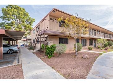 Well-maintained apartment building exterior with tidy landscaping and convenient covered parking spaces at 605 S Royal Crest Cir # 20, Las Vegas, NV 89169