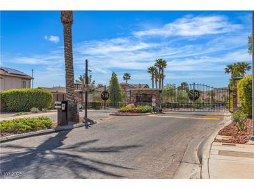 A gated entry welcomes residents to the Stetson Ranch community, featuring lush landscaping and a secure entrance at 6148 Whitelion Walk St, Las Vegas, NV 89148
