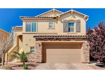 Two-story home boasting a two-car garage, stone accents, and a well-maintained front yard at 6773 Bristle Falls St, Las Vegas, NV 89149