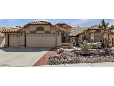 Charming single-story home featuring a three car garage and desert landscaping at 9625 Beach Water Cir, Las Vegas, NV 89117