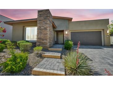 Charming single story home with a stone accent wall, three steps to the front door, and a two car garage at 10348 Bressana Dr, Las Vegas, NV 89135