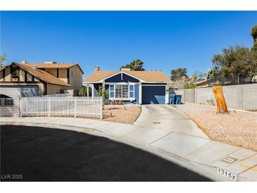 Charming single-story home featuring blue exterior, desert landscaping, and a concrete driveway at 1315 Chatsworth Ct, Las Vegas, NV 89142