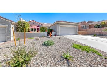 Charming single-story home featuring a low-maintenance gravel yard and a two-car garage at 2734 Grand Forks Rd, Henderson, NV 89052