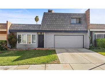 Charming two-story home featuring a two-car garage and well-maintained front yard with lush green grass at 3323 Maclyon Way, Las Vegas, NV 89121