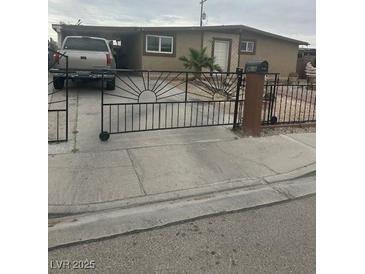 Charming single story house with a desert-style front yard and a quaint wrought-iron gate at 3616 Reynolds Ave, North Las Vegas, NV 89030