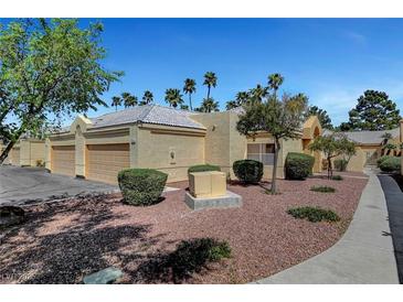 Charming single-story home with a two-car garage, desert landscaping, and a tiled roof at 364 Wild Plum Ln, Las Vegas, NV 89107