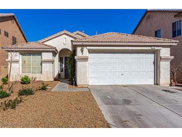 Charming single-story home features a two-car garage and desert landscaping for easy maintenance at 5046 Great Abaco St, North Las Vegas, NV 89031