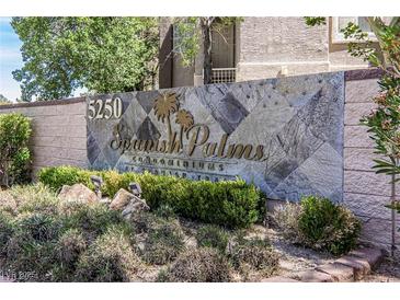 Attractive stone sign for Spanish Palms Condominiums surrounded by lush landscaping at 5250 S Rainbow Blvd # 2046, Las Vegas, NV 89118