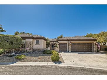 Charming single-story home featuring desert landscaping, stone accents, and a spacious three-car garage at 2021 Evansdale St, Henderson, NV 89052