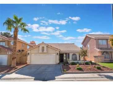 Charming single-story home featuring desert landscaping, a tile roof and an attached two-car garage at 2124 Brighton Shore St, Las Vegas, NV 89128