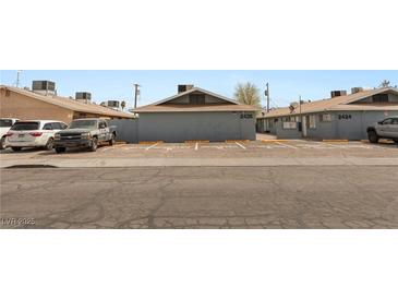 View of the street in front of the apartments and the assigned parking spaces at 2426 Statz St, North Las Vegas, NV 89030