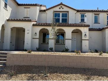 Attractive multi-level home with stucco exterior, red tile roof, arched entryways and manicured landscaping at 3667 Inspirato Ave, Henderson, NV 89044