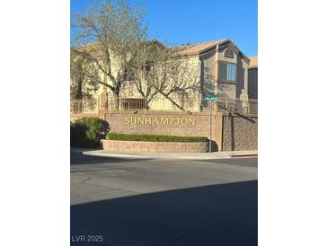 Condo exterior with brick signage showing the community's name on a sunny day at 3672 Angela Robin St # 202, Las Vegas, NV 89129