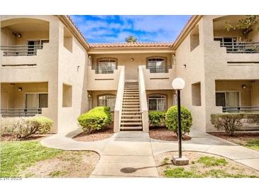 Apartment building exterior shows manicured landscaping and walkways leading to the units at 5415 W Harmon Ave # 1119, Las Vegas, NV 89103