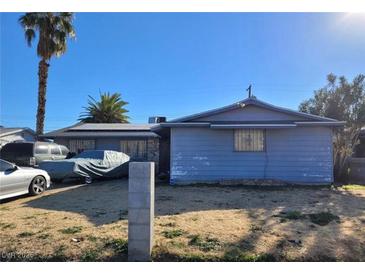 Modest single story home with front yard, covered vehicle, and mature landscaping at 5809 Pebble Beach Blvd, Las Vegas, NV 89108