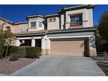 Two-story home featuring a two-car garage, desert landscaping, and a terracotta tiled roof at 6020 Genovese Ave, Las Vegas, NV 89141