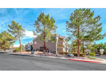 Exterior angle of complex featuring mature landscaping and reserved parking at 701 Capri Dr # 16B, Boulder City, NV 89005