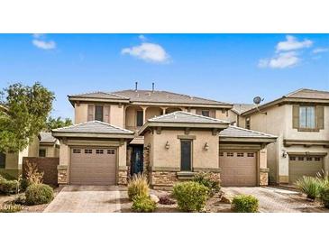 Charming two-story home featuring a three car garage, and desert landscaping at 8216 Swallow Falls St, North Las Vegas, NV 89085