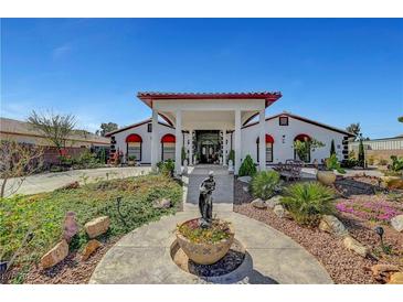 Elegant home featuring a grand entrance, manicured landscaping, and a welcoming walkway at 8365 Haven St, Las Vegas, NV 89123