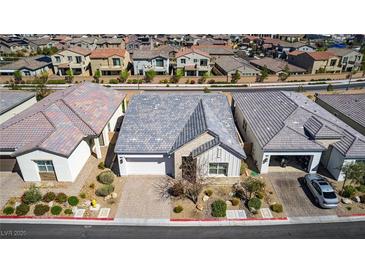 Beautiful single-story home showcasing modern architecture, a two-car garage, and expertly landscaped front yard at 8944 Skye Canyon Ranch St, Las Vegas, NV 89166