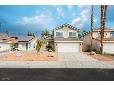 Charming two story home featuring a two car garage and desert landscaping at 9004 Crystal Glass Dr, Las Vegas, NV 89117