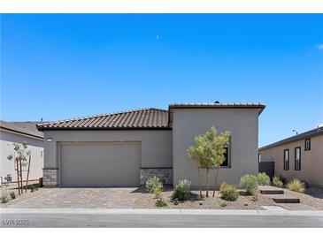 Charming single-story home showcasing desert landscaping, tile roof, and a two-car garage at 10158 Super Jovian St, Las Vegas, NV 89143