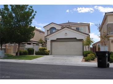 Charming two-story home featuring a well-manicured front yard and an attached two-car garage at 11039 Pegasus Dr, Las Vegas, NV 89135